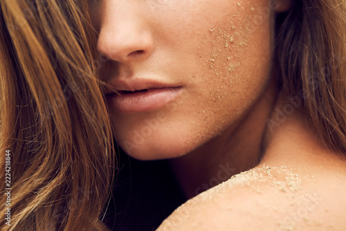 Woman with sand on her cheek, close-up
