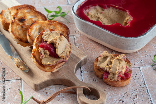 Delicious Spread of Liver Pate Served With Toasted Bread and Jelly on a Wooden Board