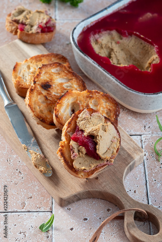 Delicious Spread of Liver Pate Served With Toasted Bread and Jelly on a Wooden Board
