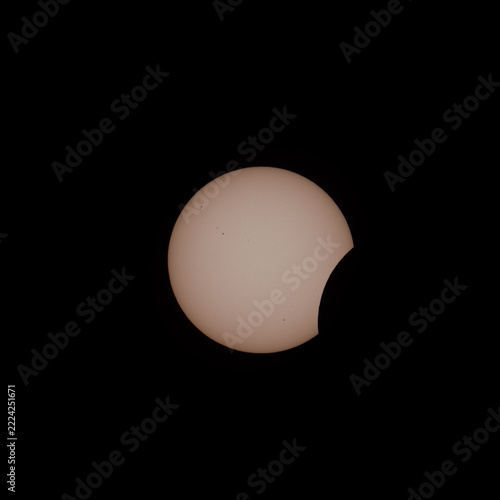 Early Partial Solar Eclipse With Sunspots on Black Sky