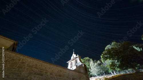 Stone Church Beneath Diagonal Star Trails at Night