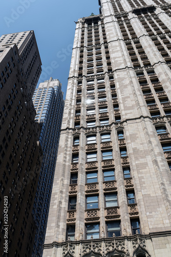 2019 New York City, USA; Low angle view of the historic neo-Gothic Woolworth Building skyscraper facade with Barclay Tower in Lower Manhattan