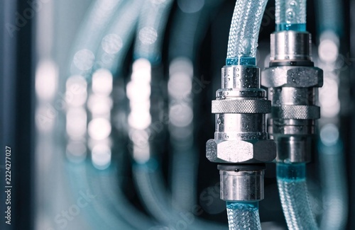 Industrial water cooling system pipes with metal connectors glowing in a high tech facility