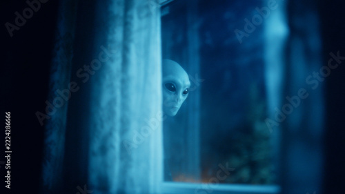Alien peeking through window at night