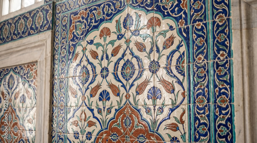 Turkish ceramic tile decoration on mosque wall featuring intricate patterns and vivid colors, showcasing floral motifs. Traditional Turkish ceramic tile art enhances beauty in mosques.