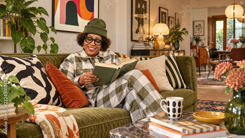 Woman Relaxing on Sofa Reading Book at Home