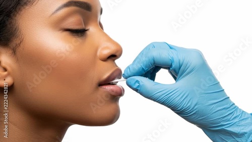 Medical Professional Administering Oral Swab Test on a Young African American Woman.