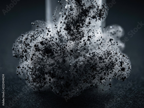 Ink pigment particles create dynamic suspension, showcasing intricate textures and forms