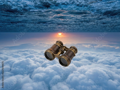 Vintage binoculars floating above clouds and ocean waves create surreal scene