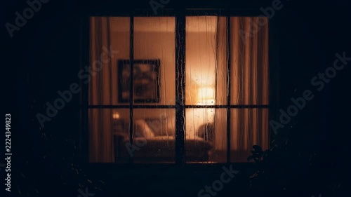 Cozy Bedroom Window View at Night Warm Light Glows Through Curtains.