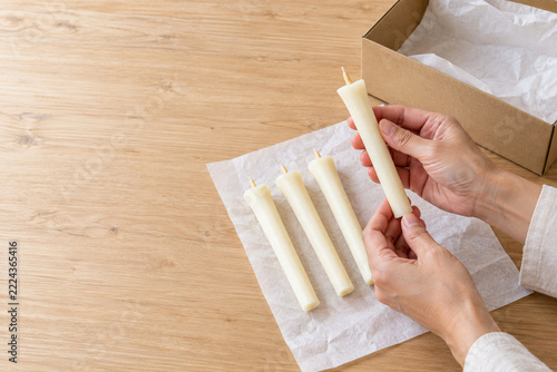 Japanese hands inspecting handmade warosoku candles before shipping