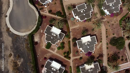 An aerial view of a residential area with houses roads and landscaping