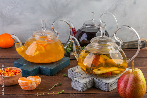 Spiced tea in glass teapots, a warming sea buckthorn drink, pear tea, thyme tea