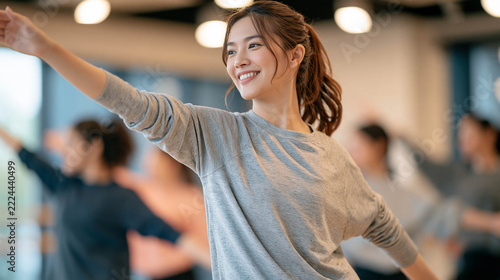 Asian Women Practicing BODYBALANCE Yoga and Gentle Stretching in a Fitness Studio