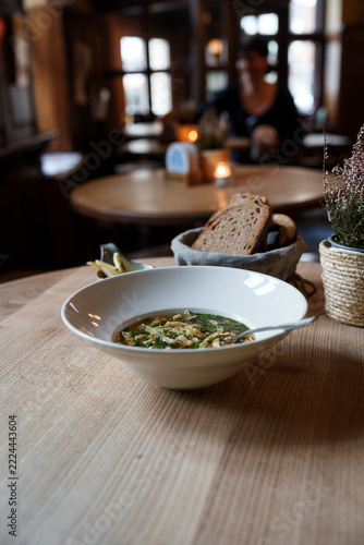 Pancake strip soup with chives served with bread and butter, top view