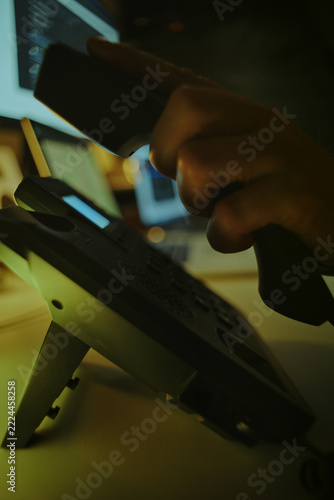 Scammer Making Telephone Call Among Computer Screens. Telephone Fraud Concept.