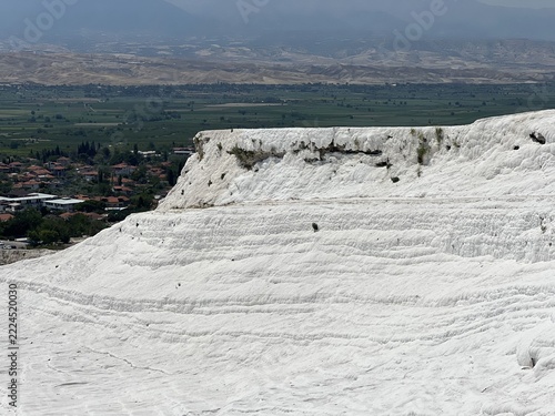 Obraz na plátně A mountain of snow-white cotton in Pamukkale, framed by mountains