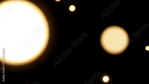 Large Soft Golden Bokeh Orbs Drifting across Black with Tiny Glitter Particles for an Elegant Celebration Background