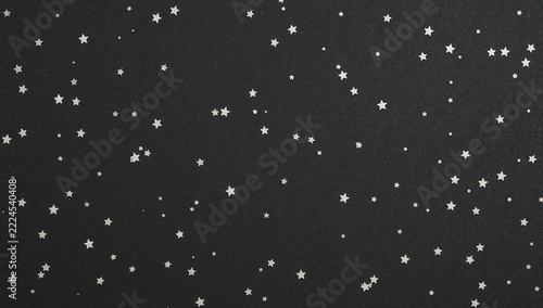A black and white photo of stars shining in the night sky