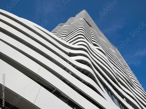 Modern architectural building with unique curved white facade against