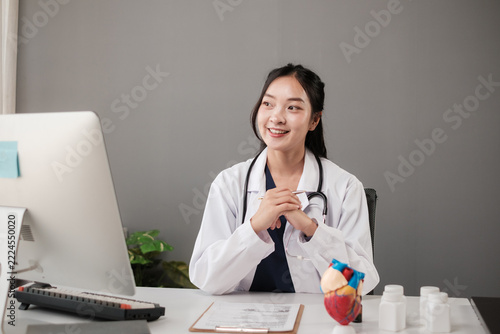Young female doctor smiling and working in office