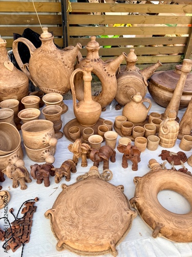 Handmade clay pottery, jugs, cups, and elephant souvenirs at outdoor craft market
