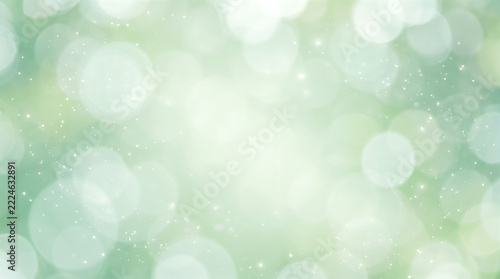 Abstract green spring nature background with soft glowing bokeh lights and magic sparkle dust