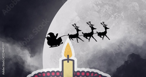 Showing lit candle on ornate base glowing nightly, full moon framing Santa hat, sleigh, 3 reindeer