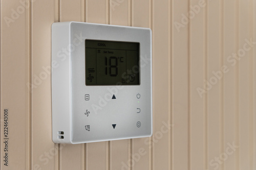 Digital Climate Control Thermostat Mounted On Wood Panel Wall