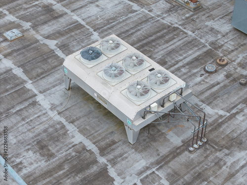 Melbourne, VIC, Australia - 14 October 2026: Aerial view of Bayswater North Factories, showing an industrial HVAC cooling unit with multiple fans installed on a flat rooftop.