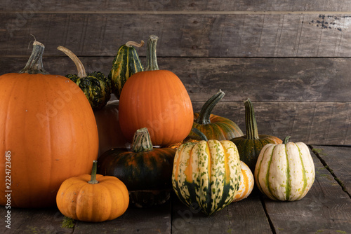 Flat lay arrangement with pumpkins on wooden background