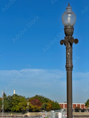Ornate vintage street lamp against blue sky