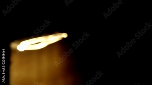 Abstract Blurred Golden Light Streaks Against A Deep Black Background