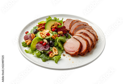 Sliced duck breast served alongside fresh greens, cucumber, seeds, and juicy pomegranate