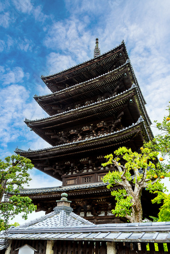 Historic 5-story Yasaka Pagoda as seen on Sannenzaka, a well-preserved stone-paved path dating back to 808 AD. The ancient 46m tall wooden pagoda is a beautiful example of Hakuho Period architecture.