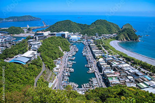 Under the blue sky, overlooking the Nanfangao Fishing Harbor filled with moored fishing boats.