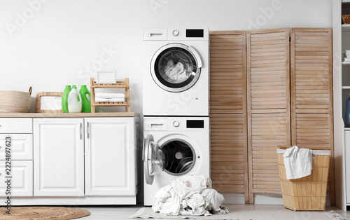 Household chores and laundry routine, modern washing machine and dryer stack ...