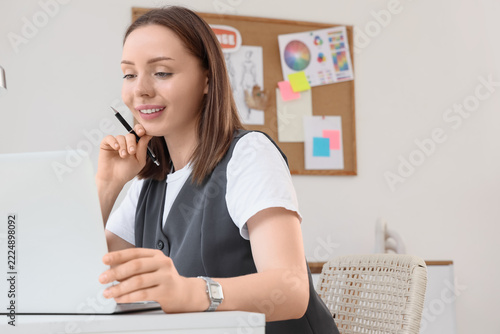 Remote work and career development, young woman working on laptop in modern o...