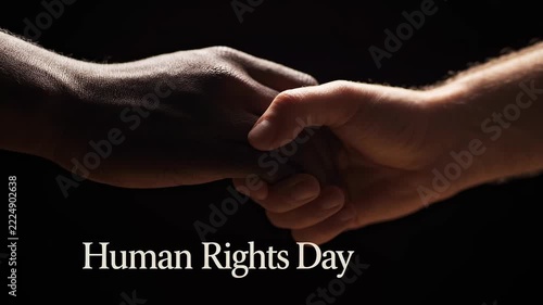 Symbolic image capturing diverse hands clasped together in unity, representing human rights, equality, and global solidarity on a dark, illuminated background