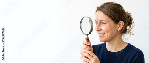 Curious Woman Examining with Magnifying Glass Smiling Looking for Details