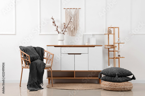 Interior design and home comfort, cozy living room with rattan chair and mode...