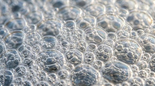 Close-up of translucent soap bubbles forming a shimmering, intricate pattern on a soft surface