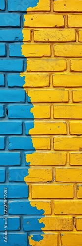 Faded blue and yellow paint on a worn brick wall, separation, division