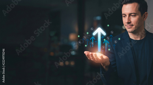 Businessman holding glowing upward arrows and percentage hologram representing financial growth and ROI