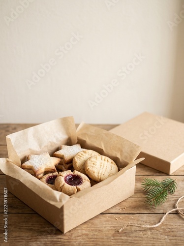 Rustic wooden box filled with assorted homemade baked goods on neutral table