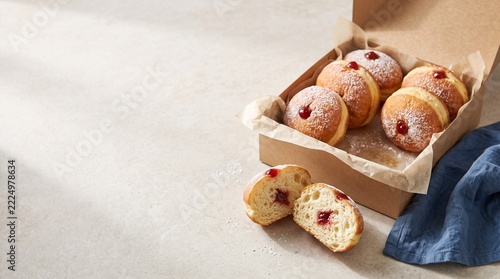Homemade baked donuts in rustic wooden box with cloth napkin