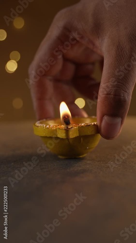 Keeping Traditional Clay Diwali Diyas with Flickering Flames Arranged on an Ornate Golden Patterned Surface, Warm Festive Close-Up Shot.