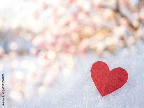 Red Paper Heart on Soft Snow with Bokeh Background