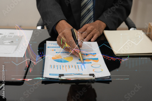financial asian advisor showing plan of investment to clients in the consultancy office.