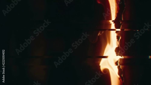 Glitch fire burning along a vertical split with digital distortion lines cutting across the darkness.